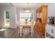 Bright dining area with a wooden table, chairs, and a view to the outdoor deck at 65 Cold Harbor Ct, Sharpsburg, GA 30277