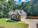 Beautiful single-Gathering home with an attached garage, mature trees, and a well-maintained lawn at 65 Cold Harbor Ct, Sharpsburg, GA 30277