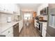 Well-equipped kitchen with stainless steel appliances and easy access to the dining area at 65 Cold Harbor Ct, Sharpsburg, GA 30277