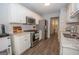Modern kitchen with white cabinets, stainless steel appliances, and granite countertops at 65 Cold Harbor Ct, Sharpsburg, GA 30277