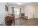 Inviting living room boasts wood-look flooring, natural light, and wainscoting details at 65 Cold Harbor Ct, Sharpsburg, GA 30277