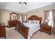 Spacious main bedroom boasts a tray ceiling, carpet floors, and an ensuite bathroom at 65 Cold Harbor Ct, Sharpsburg, GA 30277