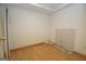 Bare room with laminate flooring, white walls, an access door, and exposed plumbing for a bathroom or laundry area at 65 Cold Harbor Ct, Sharpsburg, GA 30277