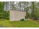 The side of the home in a lush green backyard features ample green space at 447 Sherwood Cir, Stone Mountain, GA 30087