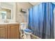 Bathroom featuring a vanity, toilet and blue stripped shower curtain at 447 Sherwood Cir, Stone Mountain, GA 30087