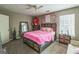 Cozy bedroom featuring a plush bed, floral decorations and a large window at 447 Sherwood Cir, Stone Mountain, GA 30087