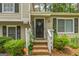 Inviting front entrance with manicured shrubs, a charming front door, and brick steps at 447 Sherwood Cir, Stone Mountain, GA 30087