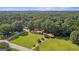 Sprawling property featuring a well-maintained home, carport, and lush landscaping, surrounded by dense woods at 6674 Cowan Mill Rd, Winston, GA 30187