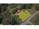 Aerial view of a well-maintained home with a red roof, nestled on a spacious green lot with mature trees at 6674 Cowan Mill Rd, Winston, GA 30187