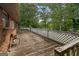 Large wooden deck with white lattice railing, offering a serene outdoor space with views of the surrounding greenery at 6674 Cowan Mill Rd, Winston, GA 30187