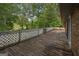 Spacious wooden deck with white lattice railing, perfect for enjoying the surrounding nature and outdoor gatherings at 6674 Cowan Mill Rd, Winston, GA 30187