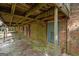 View of the covered back porch and its brick supports, wooden beams, and access doors to the house at 6674 Cowan Mill Rd, Winston, GA 30187