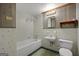 Retro bathroom featuring a tiled shower-tub, sink, and toilet, with decorative shelving and linoleum flooring at 6674 Cowan Mill Rd, Winston, GA 30187