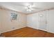 This bedroom offers hardwood flooring, a ceiling fan, a window, and a door leading outside at 6674 Cowan Mill Rd, Winston, GA 30187