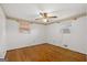 This bright bedroom features hardwood flooring, two windows, and a ceiling fan at 6674 Cowan Mill Rd, Winston, GA 30187