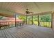 Spacious wooden deck with a ceiling fan, providing an excellent view of the backyard at 6674 Cowan Mill Rd, Winston, GA 30187