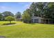 Detached garage with covered parking on a large lot with mature trees and a view of the home at 6674 Cowan Mill Rd, Winston, GA 30187