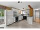 Bright kitchen with white cabinets, retro countertops, black appliances, and backyard access at 6674 Cowan Mill Rd, Winston, GA 30187