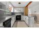 Well-lit kitchen features white cabinetry, a black oven, and gray countertops with a neutral floor at 6674 Cowan Mill Rd, Winston, GA 30187