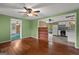 Open-concept living area with hardwood floors seamlessly connects to the kitchen with white appliances at 6674 Cowan Mill Rd, Winston, GA 30187