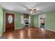 Inviting living room with wood floors, brick fireplace, and a front door with decorative glass at 6674 Cowan Mill Rd, Winston, GA 30187