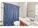 Bathroom with a blue shower curtain, wood cabinet, and marble countertop at 2619 Dayview, Atlanta, GA 30331