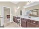 Bathroom with double vanity, dark wood cabinets, tile flooring, and a glass-enclosed shower at 2619 Dayview, Atlanta, GA 30331