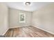 A bright bedroom with neutral walls, wood floors and a window with blinds at 2619 Dayview, Atlanta, GA 30331