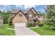 Attractive two-story home with a brick and siding design, manicured bushes, and a spacious driveway at 2619 Dayview, Atlanta, GA 30331