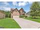 Inviting two-story home with an attached garage, lengthy driveway, and a lush green lawn at 2619 Dayview, Atlanta, GA 30331