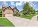 Well-maintained two-story home with an attached garage, a large driveway and a green lawn at 2619 Dayview, Atlanta, GA 30331