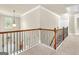 Carpeted upstairs hallway with wood and iron banister at 2619 Dayview, Atlanta, GA 30331