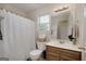 Cozy bathroom featuring a shower-tub combo with patterned curtain, wood vanity, and large mirror at 366 Whitney Ln, Mcdonough, GA 30253