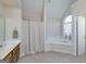 Bathroom featuring a corner soaking tub and separate shower at 366 Whitney Ln, Mcdonough, GA 30253