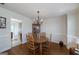 Inviting dining room features a wooden table, four chairs, hardwood floors and an ornate chandelier at 366 Whitney Ln, Mcdonough, GA 30253