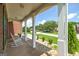 Inviting front porch with white columns, a rocking chair, and views of the lush front yard and neighborhood at 366 Whitney Ln, Mcdonough, GA 30253