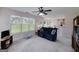 Bright living room with large windows, a ceiling fan, and views into the backyard at 366 Whitney Ln, Mcdonough, GA 30253