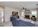 Spacious living room with a brick fireplace, ceiling fan, and comfortable blue seating at 366 Whitney Ln, Mcdonough, GA 30253