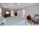 A large main bedroom featuring a tray ceiling, ceiling fan, and sitting area at 366 Whitney Ln, Mcdonough, GA 30253