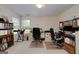 Bright office space with multiple desks, shelving, and natural light from two large windows at 366 Whitney Ln, Mcdonough, GA 30253