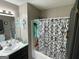 The bathroom offers a shower-tub combination, single sink, and decorative accents at 1791 Little Fawn Nw Trl, Conyers, GA 30012