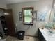 The bathroom has a single sink vanity, a window, and decorative decor at 1791 Little Fawn Nw Trl, Conyers, GA 30012