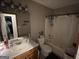 This bathroom offers a shower-tub combination, single sink, and neutral decor at 1791 Little Fawn Nw Trl, Conyers, GA 30012