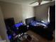 Bedroom features a bed, desk with monitor and space for gaming or working from home at 1791 Little Fawn Nw Trl, Conyers, GA 30012