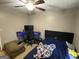 Cozy bedroom with a ceiling fan and desk is perfect for studying or relaxing at 1791 Little Fawn Nw Trl, Conyers, GA 30012