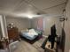 The bedroom has wood-look floors, a window, a television, and furniture at 1791 Little Fawn Nw Trl, Conyers, GA 30012