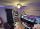 This charming bedroom has wood-look floors, a ceiling fan, and decoratiuve lighting at 1791 Little Fawn Nw Trl, Conyers, GA 30012
