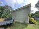 Side view highlighting the siding, trampoline, and landscaping of the backyard at 1791 Little Fawn Nw Trl, Conyers, GA 30012