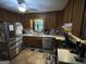 Well-lit kitchen features stainless steel appliances, wood cabinets, and functional layout at 1791 Little Fawn Nw Trl, Conyers, GA 30012