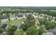 Wide aerial view of a residential neighborhood featuring mature trees and well-maintained homes with green lawns at 308 Sarasota Ln, Locust Grove, GA 30248